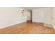 The living room features gleaming hardwood floors, neutral paint, and a doorway to an additional space at 1519 Briarfield Dr, Charlotte, NC 28205