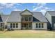 Well-maintained home back exterior with a patio, balcony, and a manicured lawn, perfect for outdoor enjoyment at 15212 Keyes Meadow Way, Huntersville, NC 28078