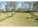 Expansive backyard featuring a well-kept lawn, privacy fence, and young trees enhancing the outdoor space at 15212 Keyes Meadow Way, Huntersville, NC 28078
