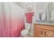 Small bathroom featuring a granite vanity, mirror, lighting, toilet, and pink shower curtain at 15212 Keyes Meadow Way, Huntersville, NC 28078