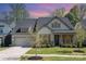Beautiful home with manicured lawn, lush shrubbery, and attached two-car garage at 15212 Keyes Meadow Way, Huntersville, NC 28078
