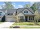 Charming home featuring a manicured lawn and inviting covered porch at 15212 Keyes Meadow Way, Huntersville, NC 28078