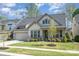 Attractive home featuring a well-kept lawn, manicured shrubbery, and an attached two-car garage at 15212 Keyes Meadow Way, Huntersville, NC 28078