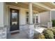 Inviting front porch with stone accents and charming bench at 15212 Keyes Meadow Way, Huntersville, NC 28078