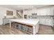Open kitchen with white cabinets, a large island, and seating at 15212 Keyes Meadow Way, Huntersville, NC 28078