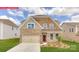 Beautiful home exterior featuring a brick and stone facade, well-manicured lawn, and an attached two-car garage at 156 Ventor Way, Mooresville, NC 28115