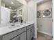 Bathroom with double sinks, quartz countertops, gray cabinets, and a large mirror at 1730 Braemar Village Dr, Monroe, NC 28110