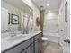 Bathroom featuring a double sink vanity, a large mirror, and a shower with a tub, offering a functional and stylish space at 1730 Braemar Village Dr, Monroe, NC 28110