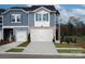 Charming townhome with white garage door, stylish siding, and well-maintained landscaping at 1730 Braemar Village Dr, Monroe, NC 28110