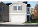 New two-story home with a two-car garage and beautiful light gray vinyl siding at 1730 Braemar Village Dr, Monroe, NC 28110