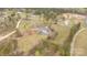 Aerial shot of home on large lot surrounded by a dense forest and neighboring houses at 1853 Beach Ln, Heath Springs, SC 29058