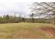 Spacious backyard with ample green space, surrounded by lush trees at 1853 Beach Ln, Heath Springs, SC 29058