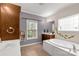 Bright bathroom featuring a soaking tub, tiled floors, double sink vanity, and a window for natural light at 1853 Beach Ln, Heath Springs, SC 29058