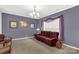Living room with burgundy sofa, and neutral carpeting and walls at 1853 Beach Ln, Heath Springs, SC 29058