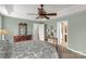 A main bedroom with high ceilings, a ceiling fan, and hardwood furniture at 1853 Beach Ln, Heath Springs, SC 29058