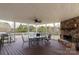 Charming covered patio with stone fireplace, ideal for outdoor dining and relaxation at 1853 Beach Ln, Heath Springs, SC 29058