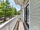 Charming balcony with a view of a tree-lined street perfect for relaxing and enjoying the outdoors at 1904 Lela Ave, Charlotte, NC 28208