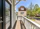 Inviting balcony with wood flooring and a view of the neighboring home and street at 1904 Lela Ave, Charlotte, NC 28208