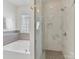 Luxurious bathroom with walk-in glass shower and soaking tub, accented by modern tile at 1904 Lela Ave, Charlotte, NC 28208