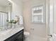 Well-lit bathroom with marble vanity, modern fixtures, and window for natural light at 1904 Lela Ave, Charlotte, NC 28208