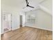 Bright bedroom with hardwood floors, ceiling fan, and large windows for ample natural light at 1904 Lela Ave, Charlotte, NC 28208