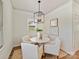 Breakfast nook with a modern light fixture and views of the backyard through a window at 1904 Lela Ave, Charlotte, NC 28208