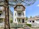 Charming two-story home featuring a white picket fence, balcony, and well-maintained landscaping at 1904 Lela Ave, Charlotte, NC 28208