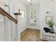 Entryway with hardwood floors, white trim, and view of the front door with a glass insert at 1904 Lela Ave, Charlotte, NC 28208