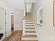Bright foyer with a wooden staircase and light wood flooring at 1904 Lela Ave, Charlotte, NC 28208