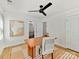 Well-lit home office with a wooden desk, chair, and white walls at 1904 Lela Ave, Charlotte, NC 28208