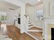Bright staircase with wood and white finishes, leading to a landing with natural light at 1904 Lela Ave, Charlotte, NC 28208