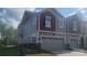 Beautiful townhome with stone accents, two-car garage, and neutral siding at 2005 Vinyasa Ln # Sts-45, Charlotte, NC 28215