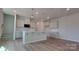 Bright kitchen with a center island, pendant lights, and white cabinets at 2005 Vinyasa Ln # Sts-45, Charlotte, NC 28215