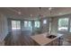 Sun-filled living area featuring wood floors, multiple windows, and sliding glass door at 2005 Vinyasa Ln # Sts-45, Charlotte, NC 28215