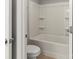 This bathroom features a tub and shower combination with built in shelves and white tiling at 2031 Killian Creek Dr, Denver, NC 28037