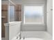 Relaxing bathroom showcases a soaking tub under a bright, sunny window at 2031 Killian Creek Dr, Denver, NC 28037