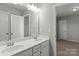 Bathroom with double sinks, large mirror, and neutral decor at 2031 Killian Creek Dr, Denver, NC 28037