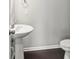 Powder room with pedestal sink, round mirror, and neutral paint at 2031 Killian Creek Dr, Denver, NC 28037