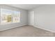 Bedroom featuring a large window and neutral carpeting at 2031 Killian Creek Dr, Denver, NC 28037