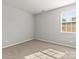 Bright and airy bedroom with carpet, neutral paint, and a large window at 2031 Killian Creek Dr, Denver, NC 28037