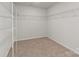 Spacious walk-in closet with built-in shelving and neutral carpeting at 2031 Killian Creek Dr, Denver, NC 28037