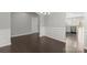 Open-concept dining room featuring hardwood floors and elegant trim, adjacent to the kitchen area for easy entertaining at 2031 Killian Creek Dr, Denver, NC 28037