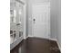 Elegant entryway with hardwood floors, a white front door, and stylish French doors, creating a grand entrance at 2031 Killian Creek Dr, Denver, NC 28037