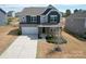 Beautiful two-story home with a well-maintained lawn, a two-car garage, and attractive architectural details at 2031 Killian Creek Dr, Denver, NC 28037