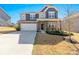 Charming two-story home featuring a stone and siding exterior, a two-car garage, and a well-manicured front lawn at 2031 Killian Creek Dr, Denver, NC 28037