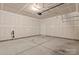 Unfinished two car garage with concrete floors and walls, and a single entry door on the back wall at 2031 Killian Creek Dr, Denver, NC 28037