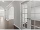 Hallway showcasing hardwood floors, white trim, and arched doorways, leading to various rooms in the home at 2031 Killian Creek Dr, Denver, NC 28037