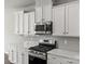 Well-equipped kitchen boasting stainless steel appliances and white cabinets at 2031 Killian Creek Dr, Denver, NC 28037