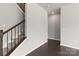 Carpeted staircase with dark wood railings, iron spindles, and natural light at 2031 Killian Creek Dr, Denver, NC 28037