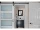 Charming bathroom with a black vanity, mirror, and a stylish frosted sliding barn door at 235 Stafford Estates Dr, Salisbury, NC 28146